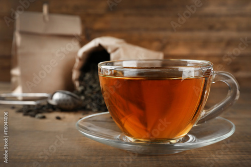 Cup of black tea on wooden table