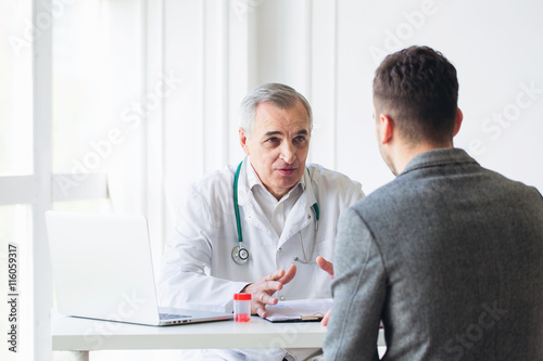 Senior doctor consults young patient