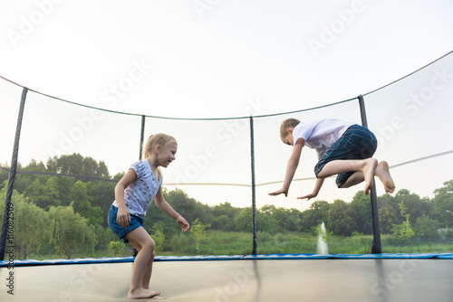 Children are jumping on trampoline