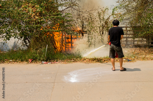 A man is trying to extinguish a fire.