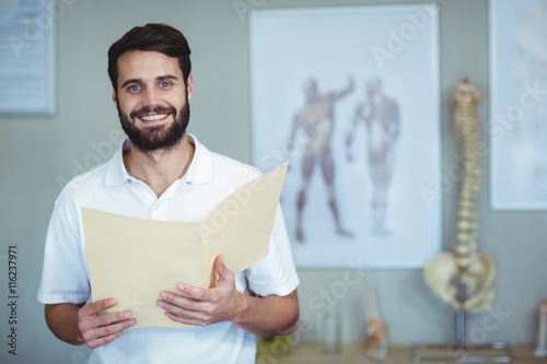 Portrait of physiotherapist holding file