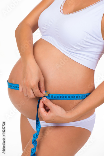 Measuring girth tummy with meter tape. Pregnancy. Pregnant belly