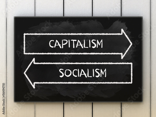 Capitalism or socialism choices on black board written with chalk.