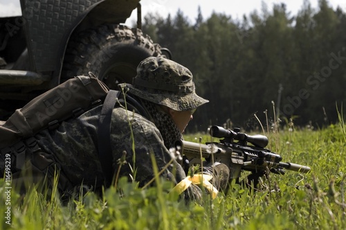 a man with a rifle at the car