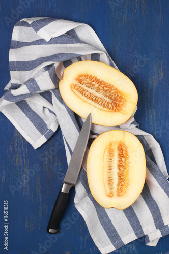 Cut melon on blue wood