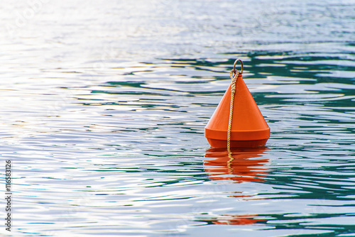 Red buoy on the sea waves