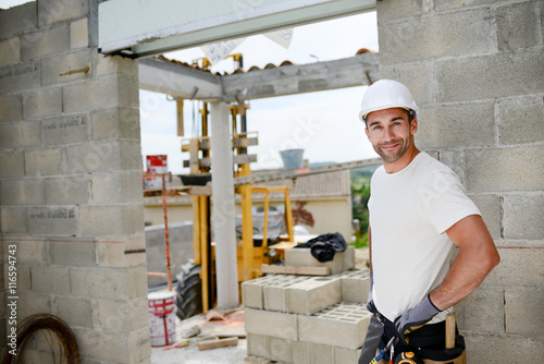 portrait of handsome construction worker on a building industry construction site