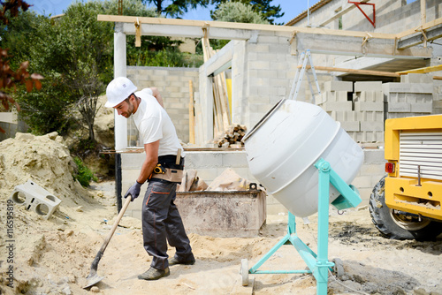 portrait of handsome construction worker on a building industry construction site