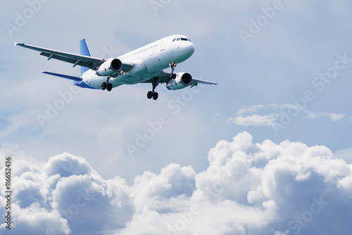 Passenger airliner flies above the clouds