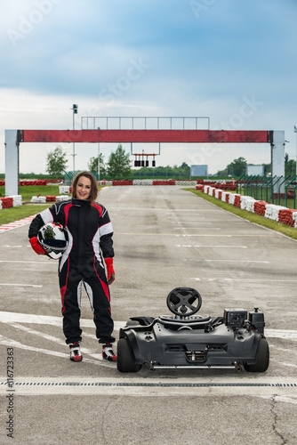 Young female go kart champion posing on the track