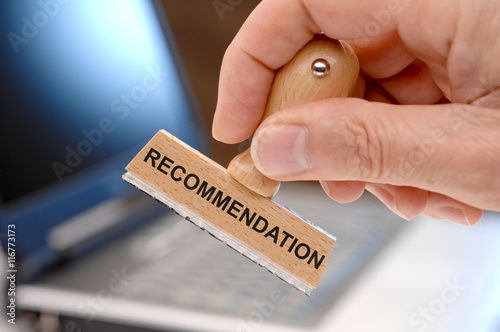 recommendation printed on rubber stamp in hand