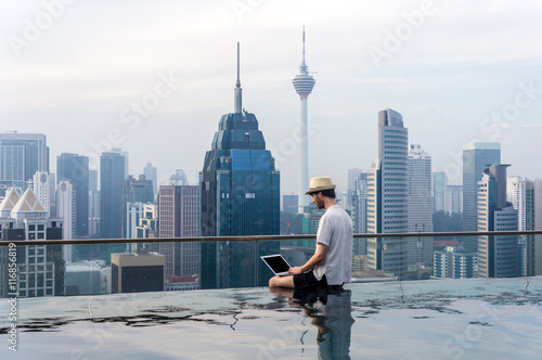 Businessman in an infinity pool