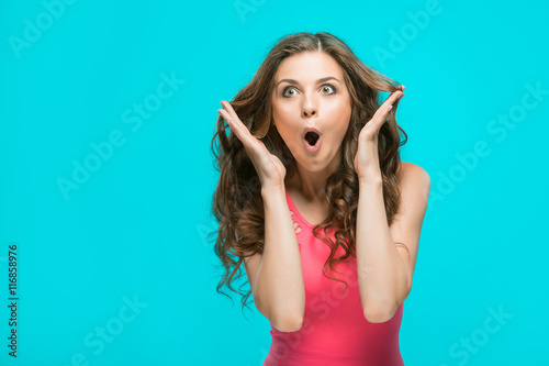 Portrait of young woman with shocked facial expression