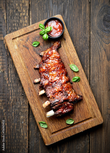 grilled ribs on a cutting board. rustic style