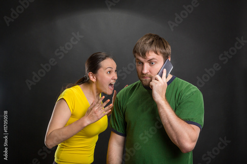 Excited couple playing wth a mobile phone