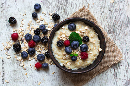 oatmeal porridge with ripe berries for breakfast. top view