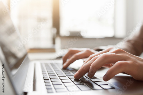 Typing on laptop closeup, chatting in Facebook, meeting website. Blogger, journalist writing new article.