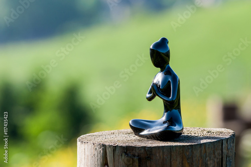 silhouette of young healthy woman practicing yoga, meditate or pray on wooden surface