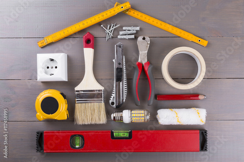 DIY construction tools on wooden background