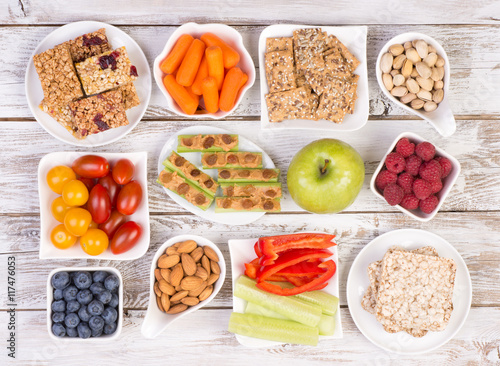 Healthy snacks on wooden table, top view