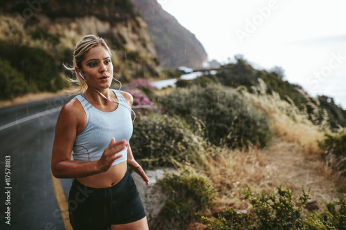 Fitness woman running outdoors in countryside
