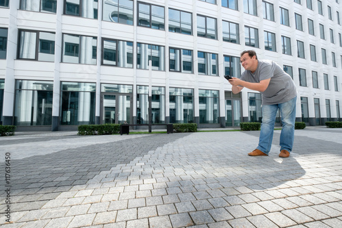 Man playing Pokemon Go game at the modern city background