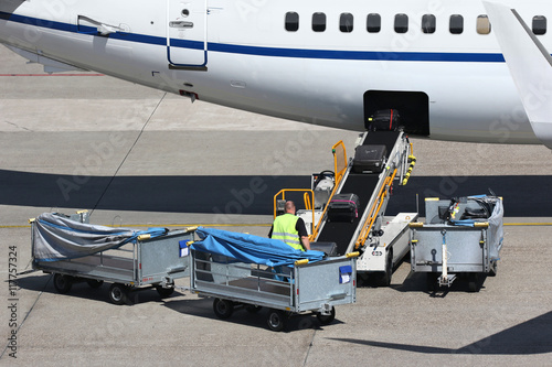 loose luggage being loaded into narrow body aircraft