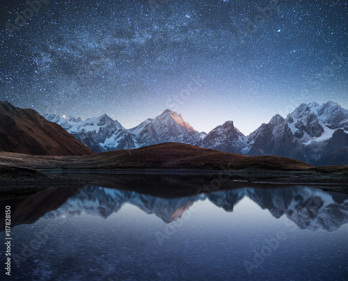 Night landscape with a mountain lake and a starry sky