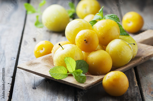 Summer sweet yellow plums on the wooden table