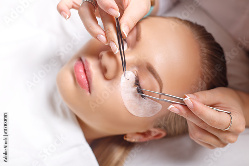 Eyelash Extension Procedure. Woman Eye with Long Eyelashes. Lashes, close up, selected focus.