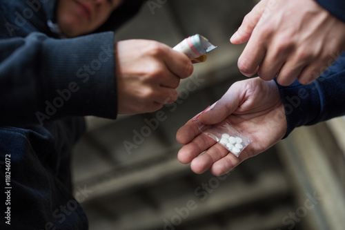 close up of addict buying dose from drug dealer