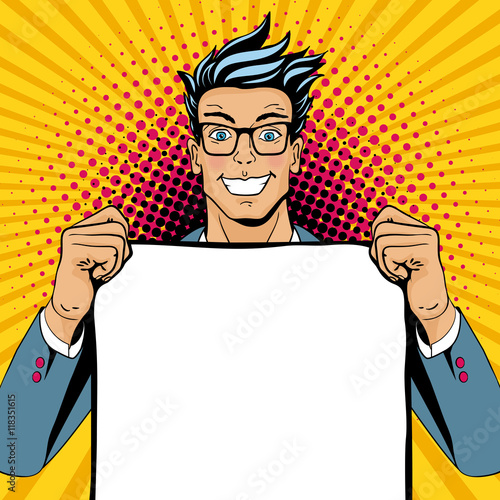 Wow pop art man. Young happy surprised man in glasses with open smile holding empty poster. Vector illustration in retro comic style. Vector pop art background.