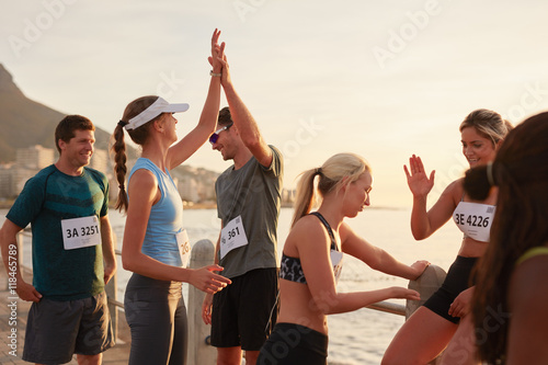 Athletes high fiving after a race