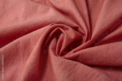 A full page close up of a swirl of brick red shirt fabric texture