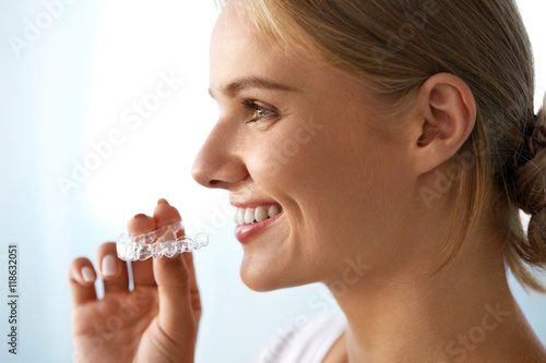 Smiling Woman With Beautiful Smile Using Invisible Teeth Trainer. High Resolution Image