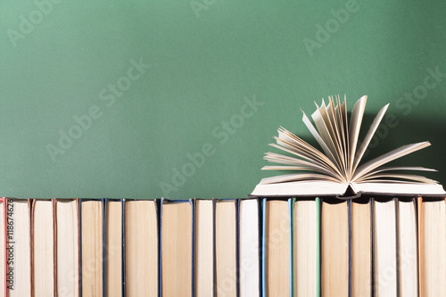 Open book, hardback books on wooden table. Education background. Back to school. Copy space for text.