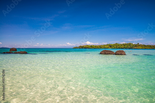 Beautiful tropical island beach in sunny day blue sky background. Summer tropical travel holiday vacation or green nature concept.
