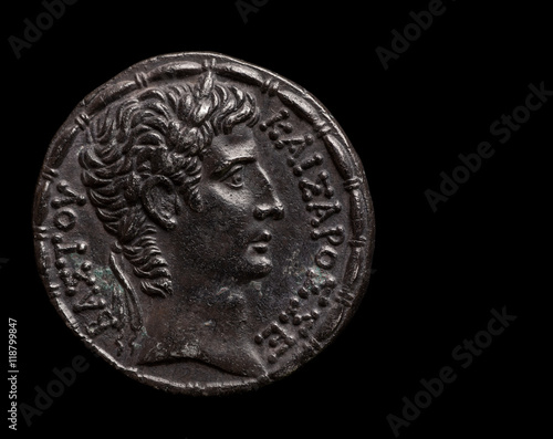 Silver ancient coin of emperor Augustus isolated on black, text space