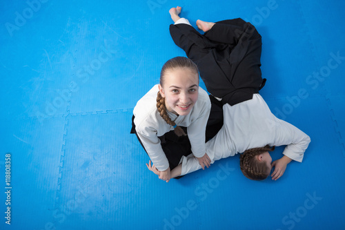Two girls in black hakama training on Aikido training
