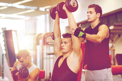 group of men with dumbbells in gym
