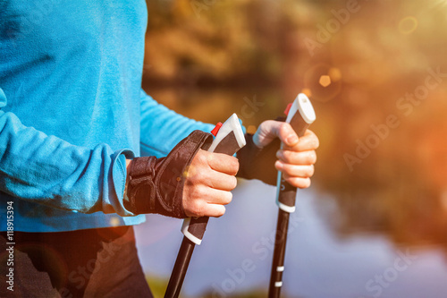 Closeup of woman's hand holding nordic walking poles