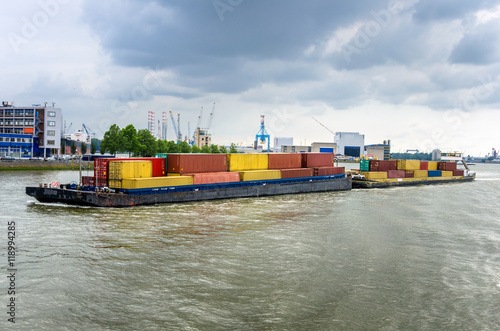 Barge full of Containers in Rotterdam on a Cloudy Day