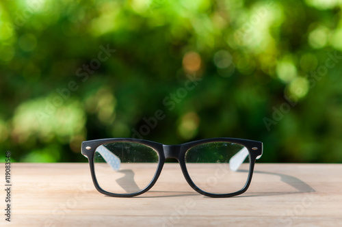 Eyeglasses on wooden table.