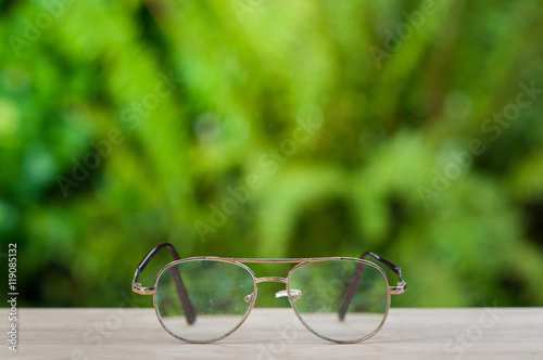 Old eyeglasses on wooden table.
