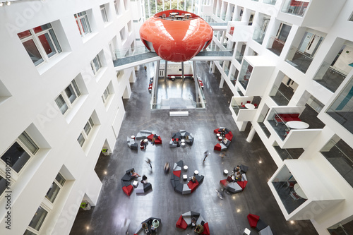 Students moving around the atrium area of modern university