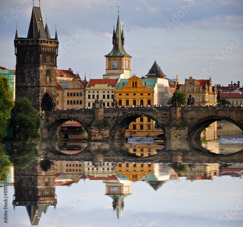 Charles bridge in Prague. Beautiful reflection of bridge on Vltava river