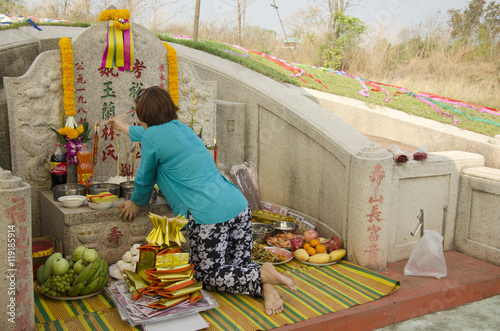 My family praying and sacrificial offering food and joss paper t