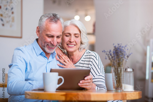 Positive loving couple sitting at the table