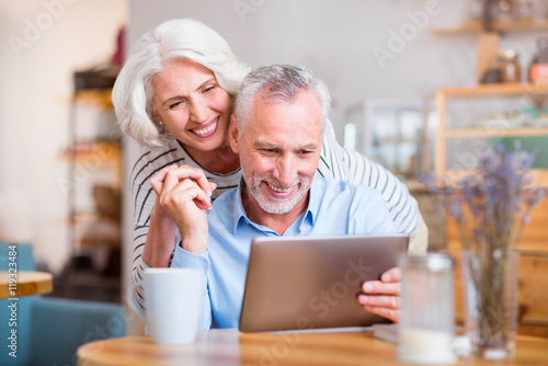 Cheerful couple using tablet