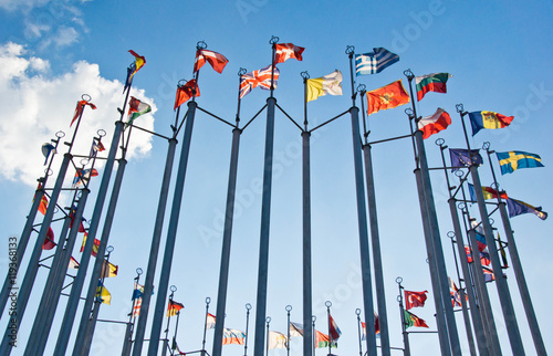 flags on background of blue sky with clouds